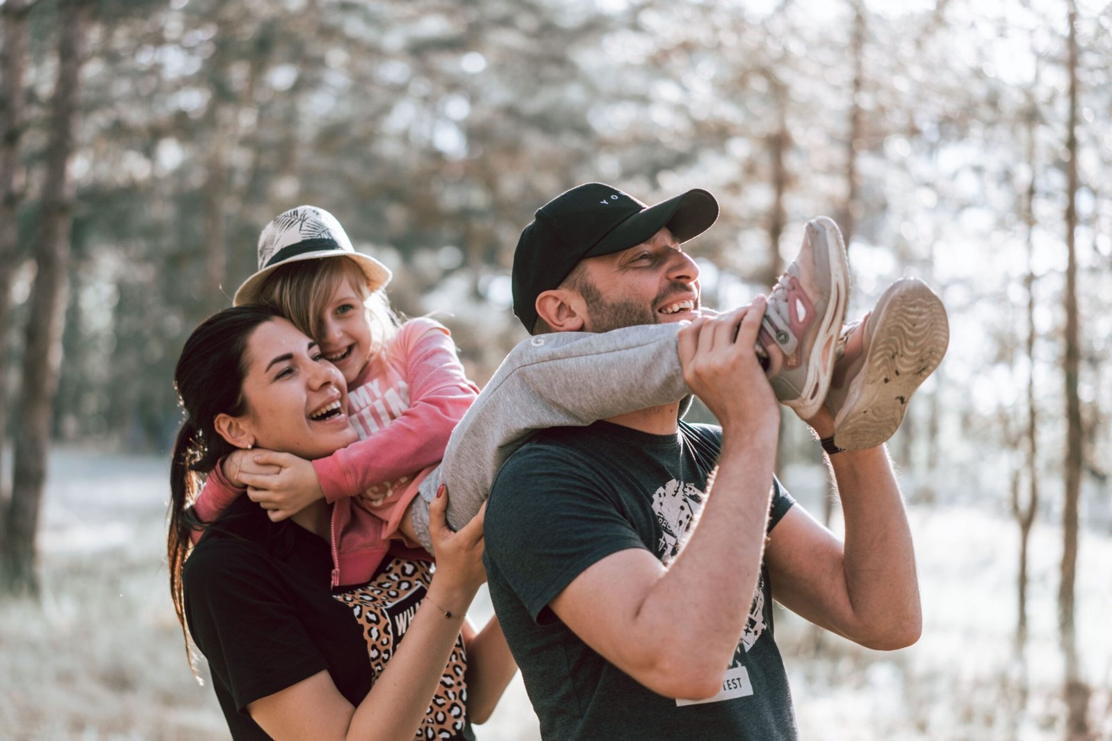 Home Happy family having fun in a forest, capturing joyful bonding moments.